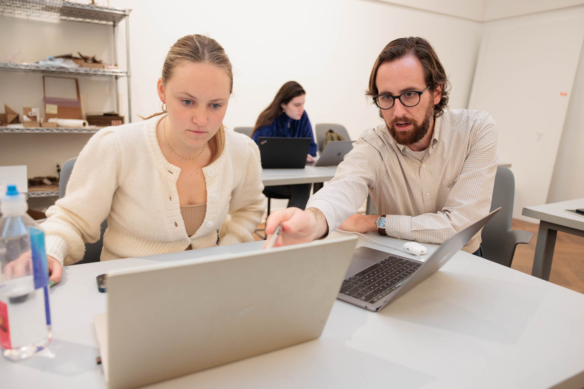 Abbie McGrann, a senior working on her B.F.A. in interior architecture, gets some help from Douglas Crawford. 