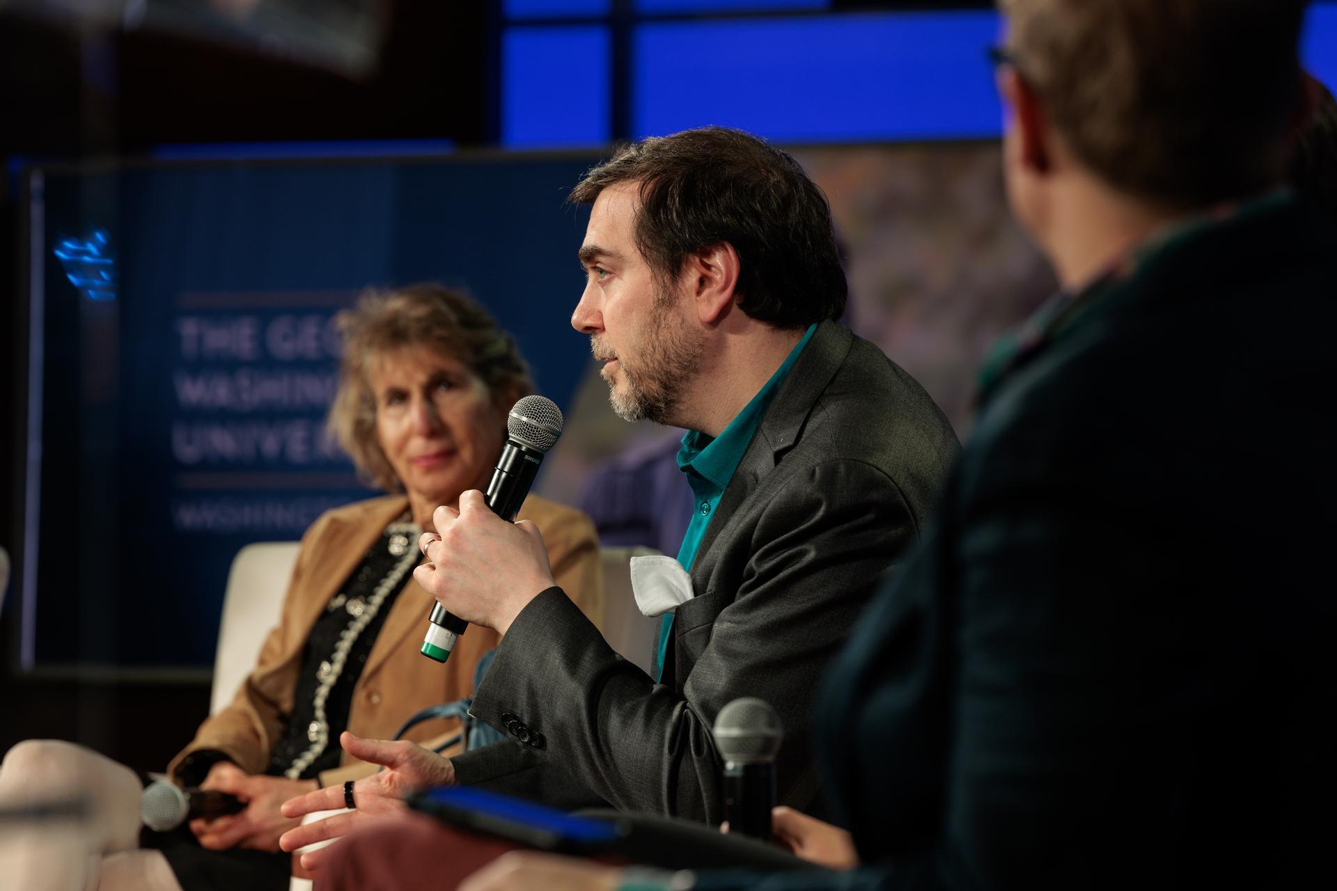 Professors Susan Ariel Aaronson and David Broniatowski on the stage at TRAILSCon 2025