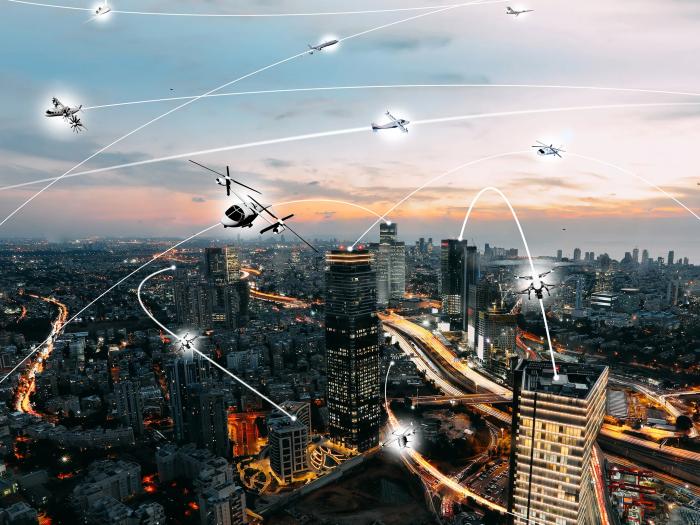 A rendering of what urban airspace might look like in the future, with autonomous aircraft navigating around each other. (NASA)